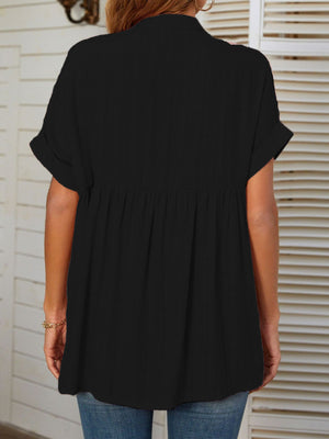 Black linen blend blouse with gathered yoke and cuffed short sleeves.