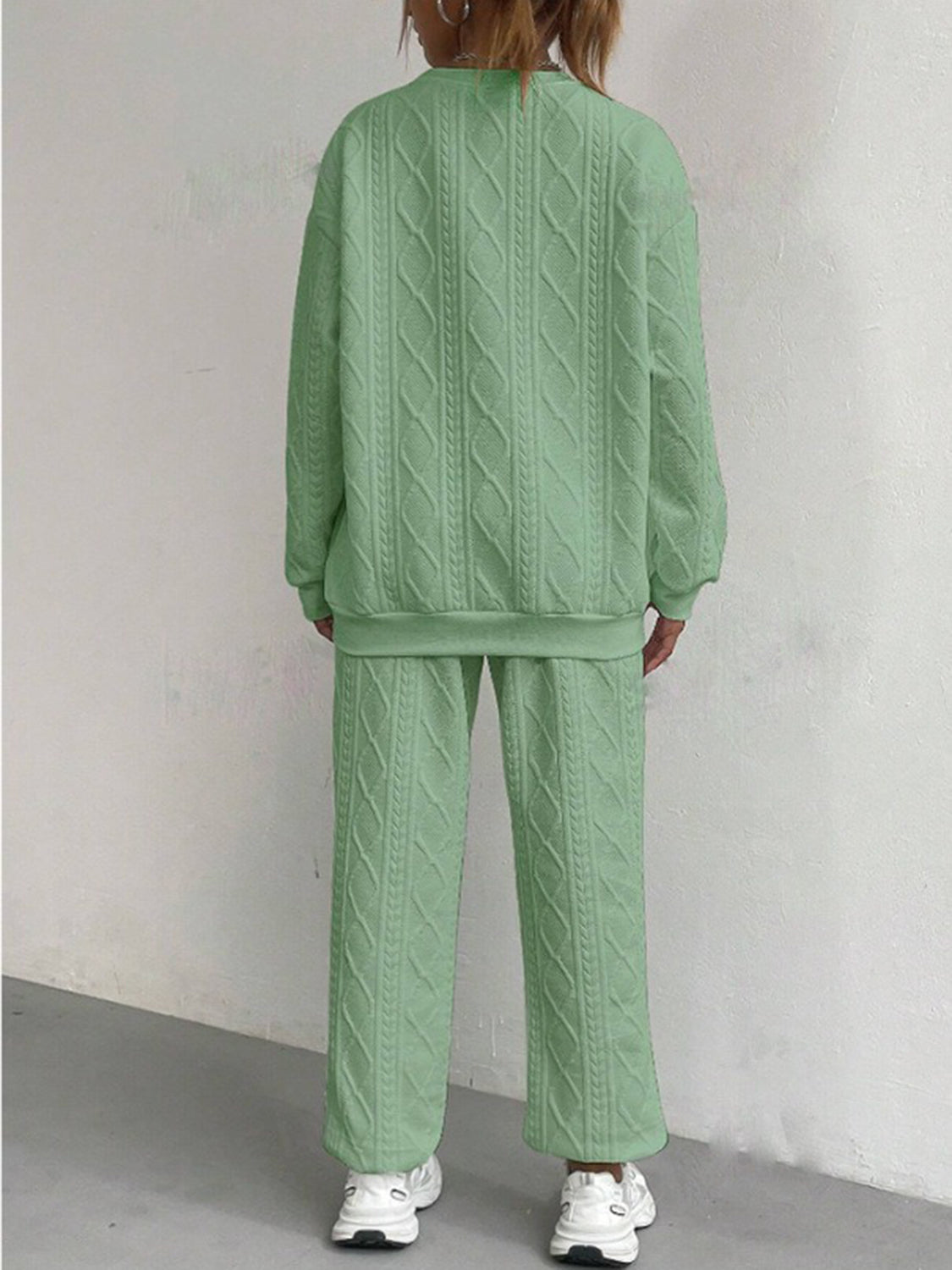 Cable knit lounge set in Gum Leaf green, featuring a crewneck sweatshirt and wide-leg pants.