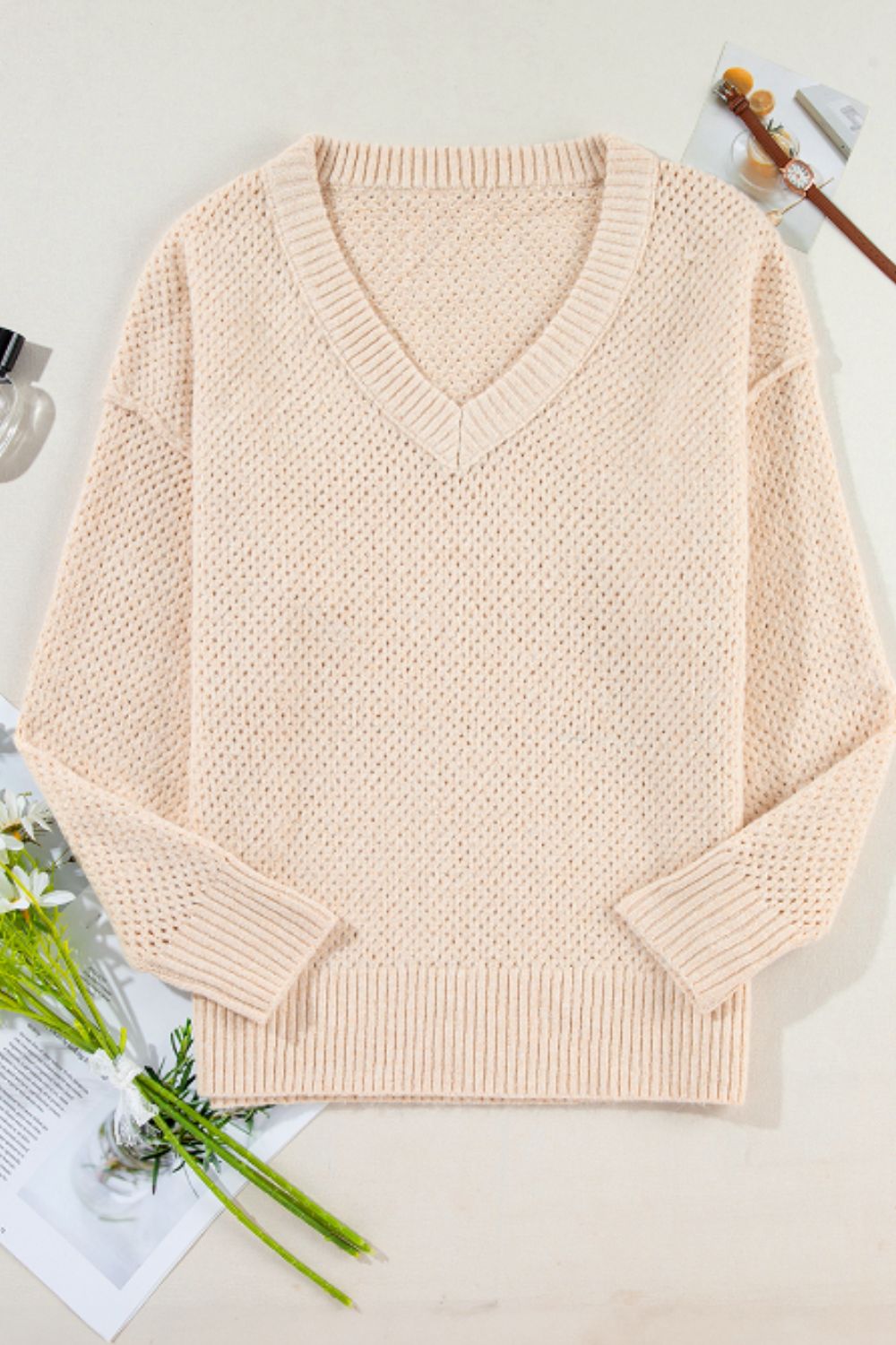 Beige open-knit V-neck sweater with ribbed cuffs and hem
