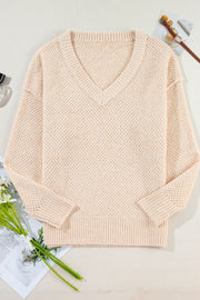 Beige open-knit V-neck sweater with ribbed cuffs and hem