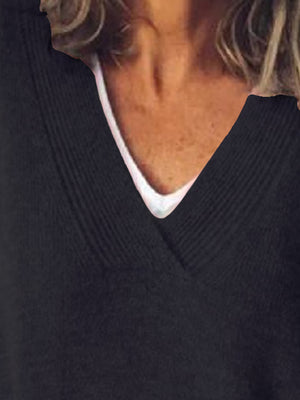 Black ribbed knit sweater with V-neck and white undershirt detail