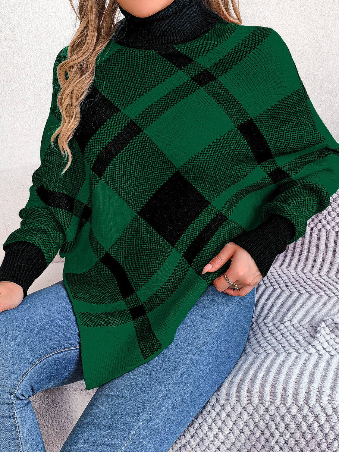 Green tartan turtleneck poncho sweater with asymmetric hem and black cuffs.