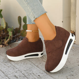 Brown chunky platform sneakers with air cushion sole and velcro strap detail.
