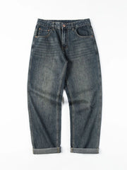 Loose fit blue cotton denim jeans with vintage wash and cuffed hems.