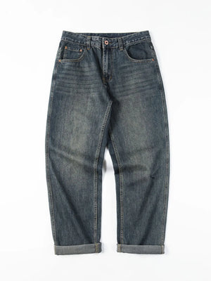 Loose fit blue cotton denim jeans with vintage wash and cuffed hems.
