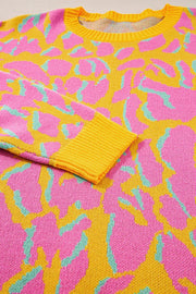 Women's crew knit sweater in fuchsia pink abstract leopard print with yellow trim.