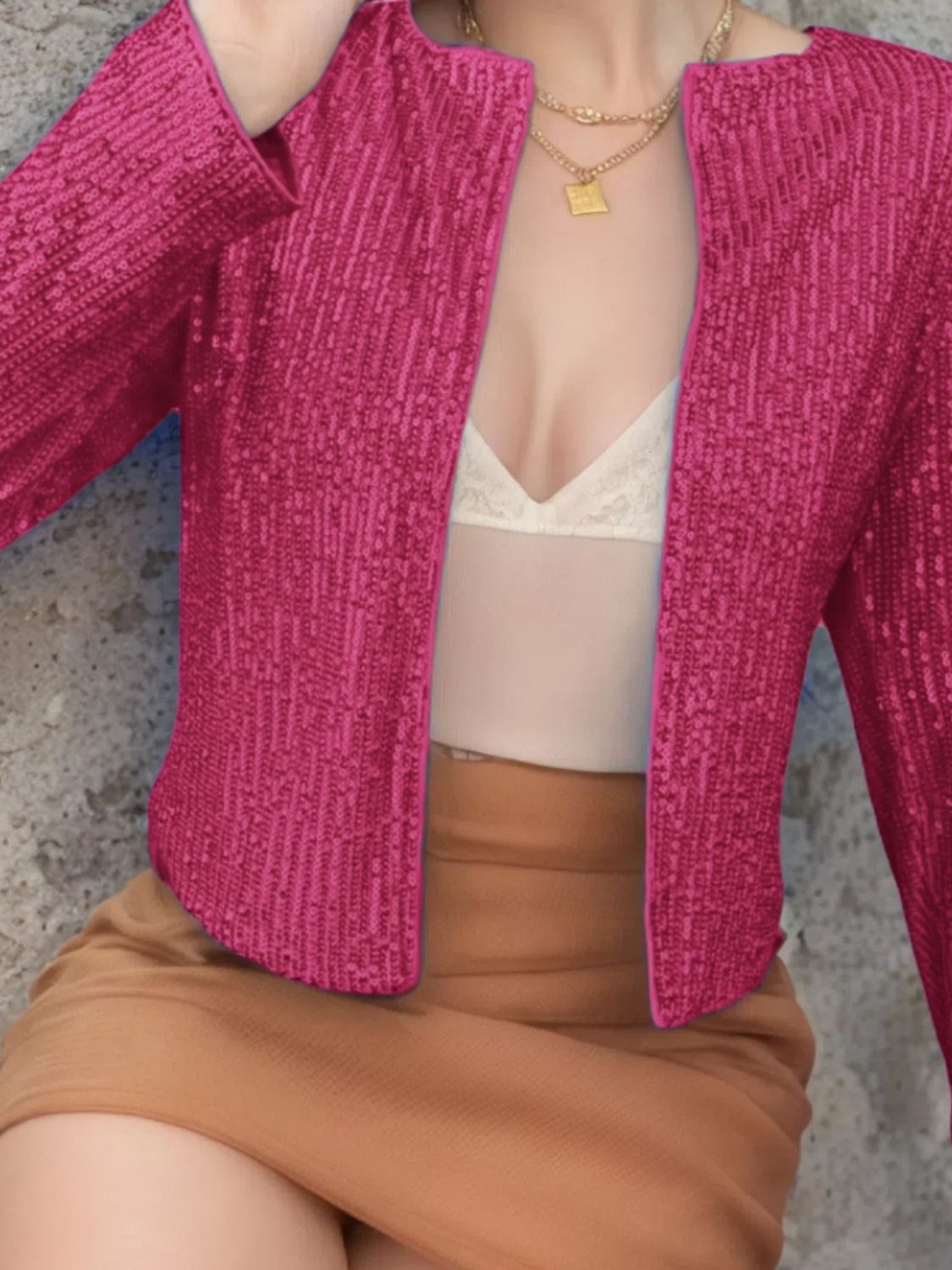 Hot Pink sequin bolero jacket with long sleeves and open front, styled with a camisole and skirt.