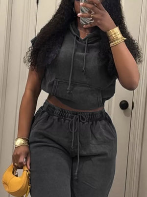 Relaxed hooded two-piece set in black cotton with drawstring waist and hoodie.