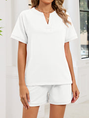 White loungewear shorts and V-neck top ensemble with drawstring waist.