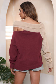 Asymmetric shoulder block sweater in deep red and beige acrylic with a boat neck.