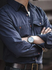 Navy cotton twill utility shirt with two chest pockets and button front.