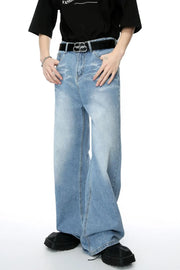 Oversized denim palazzo jeans in medium wash with subtle fading and a wide leg