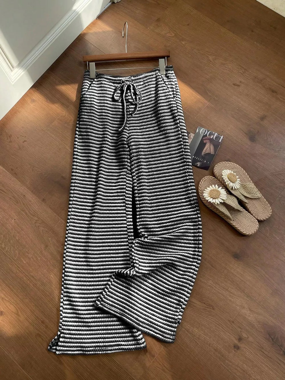 Black and white striped maternity wide leg pants with drawstring waist.