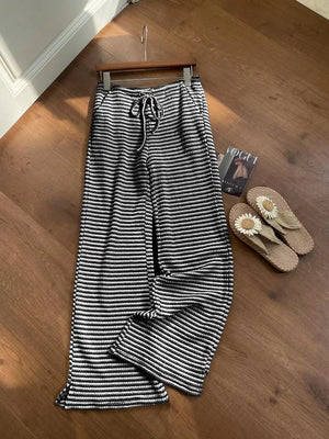 Black and white striped maternity wide leg pants with drawstring waist.