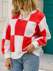 Checkerboard knit pullover sweater with balloon sleeves in red and white.