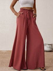 Ruffled waist palazzo trousers in rust with a drawstring and wide legs.