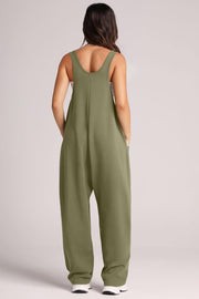 Relaxed fit jumpsuit in sage green with oversized pockets and a scoop neckline.