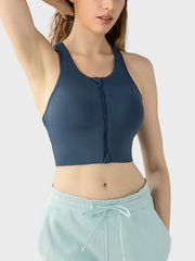 Dark blue zip-front racerback sports bra with a cropped fit.