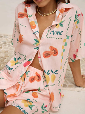 Pink co-ord pajama set with a limoncello print, button-up shirt and shorts.