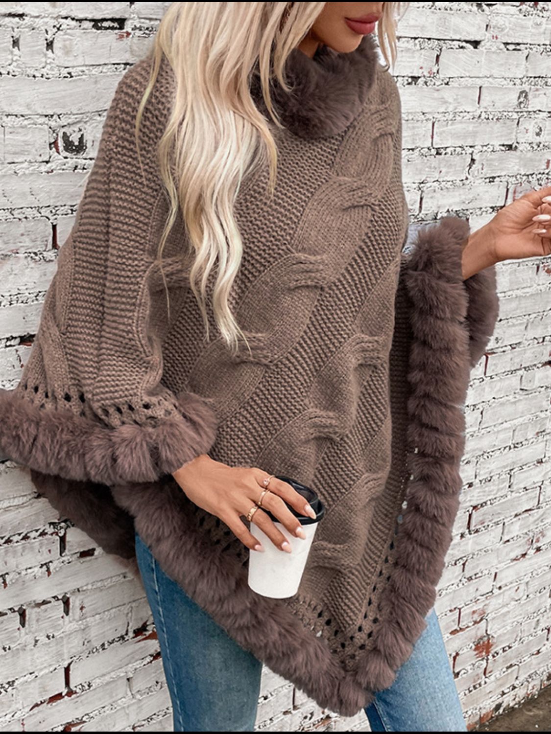 Mocha cable knit poncho with faux fur trim and open knit details.