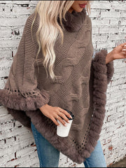 Mocha cable knit poncho with faux fur trim and open knit details.