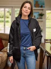 Black textured sherpa zip-up jacket with stand collar and patch detail