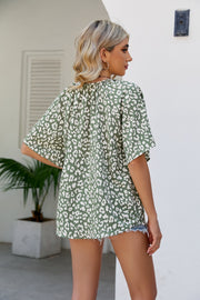 Army green leopard print v-neck blouse with short sleeves and a gathered neckline.
