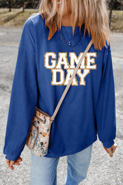 Peacock blue ribbed sweatshirt with white and gold glitter "GAME DAY" graphic.