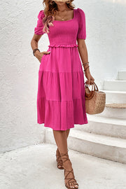 Hot pink tiered ruffle midi dress with smocked bodice and square neckline.