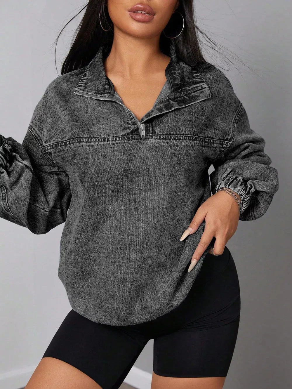Chic quarter-zip acid wash denim top with elastic hem and collar.