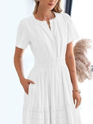 White V-neck tiered maxi dress with smocked waist and short sleeves.