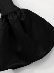 Black off-shoulder maxi dress with ruched detail and flowing skirt.