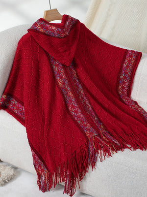 Red knit hooded wrap with diamond pattern and colorful embroidered trim.