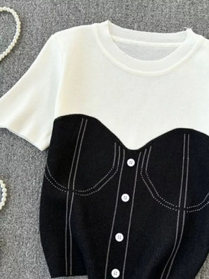 Color block knit t-shirt in white with black bustier detail and white buttons.