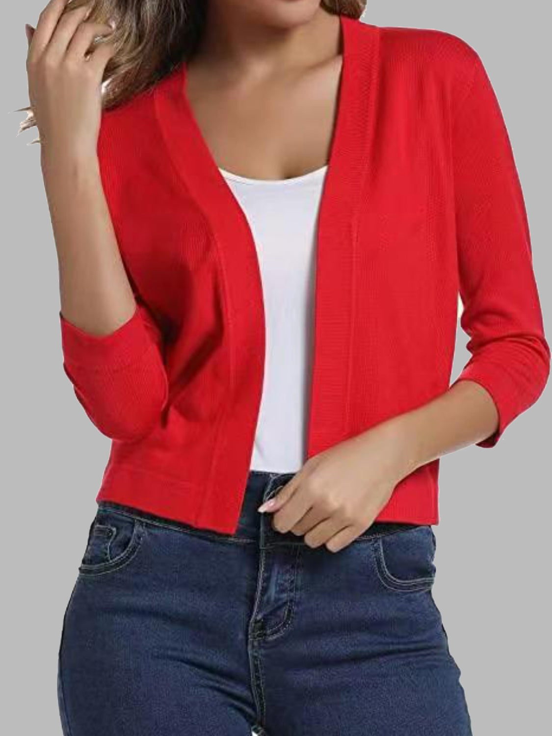 Red cropped knit cardigan with elbow sleeves and open front, styled with a white tank top and jeans.