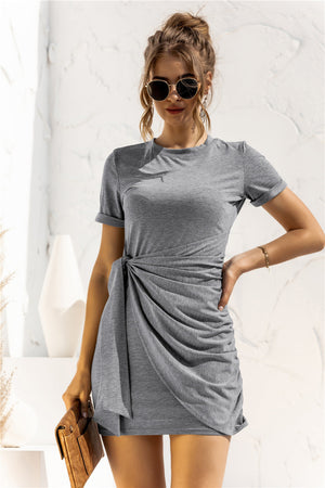 Mid gray jersey knot-front mini dress with ruched detail and short sleeves.