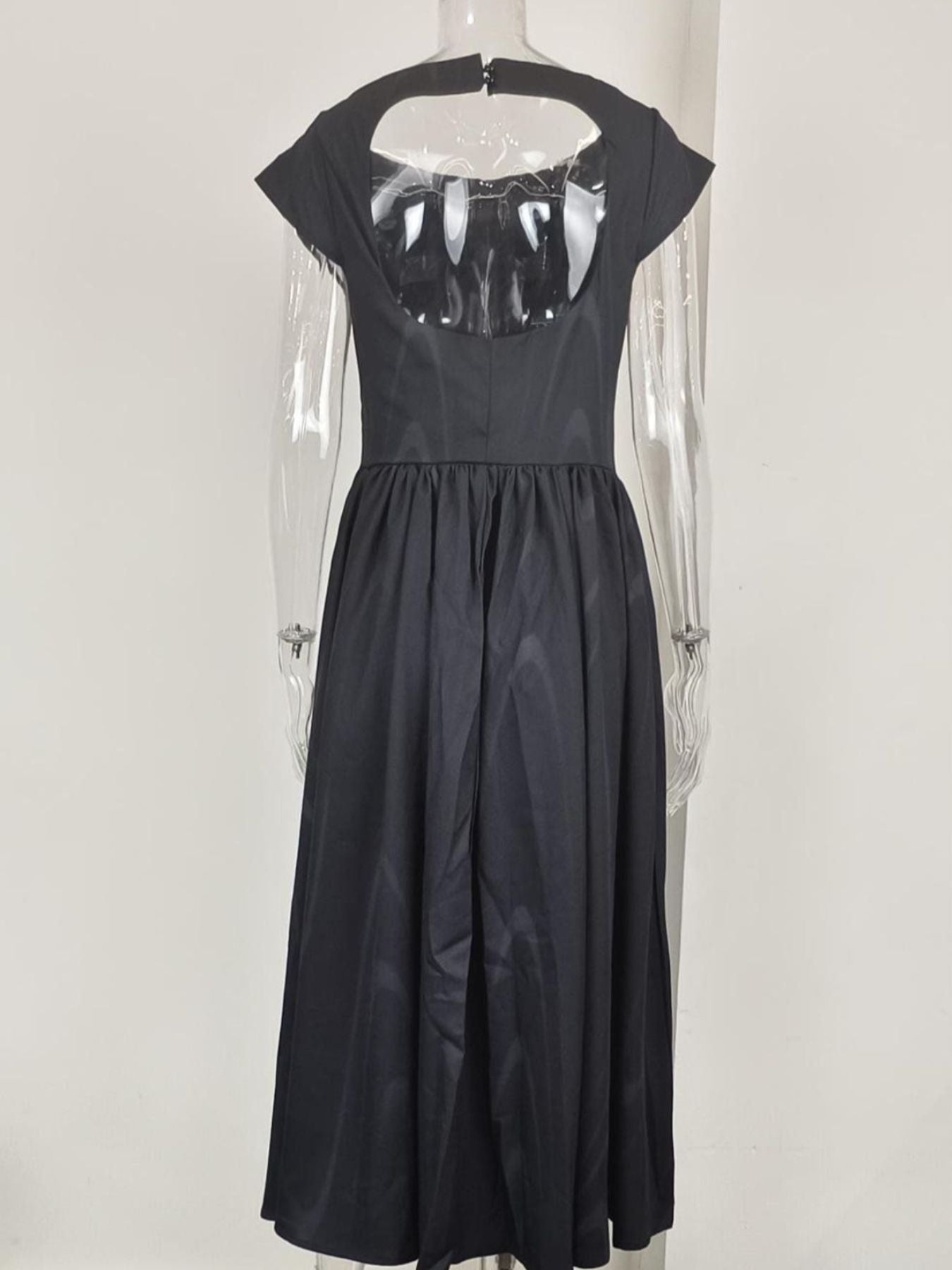 Black cap sleeve midi dress with a-line skirt and open back detail.