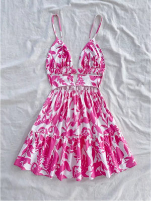 Vibrant floral cutout mini dress with spaghetti straps and tiered hem.