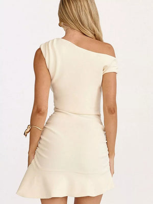 White asymmetrical ruffle hem mini dress with ruched detail and one-shoulder neckline.