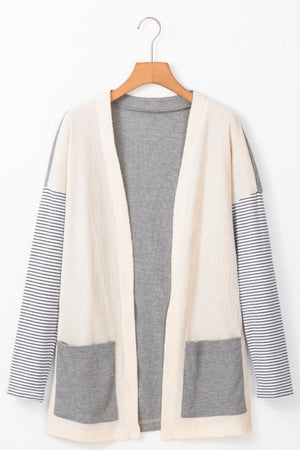 Colorblock stripe sleeve cardigan in light gray with waffle knit body and two front pockets.