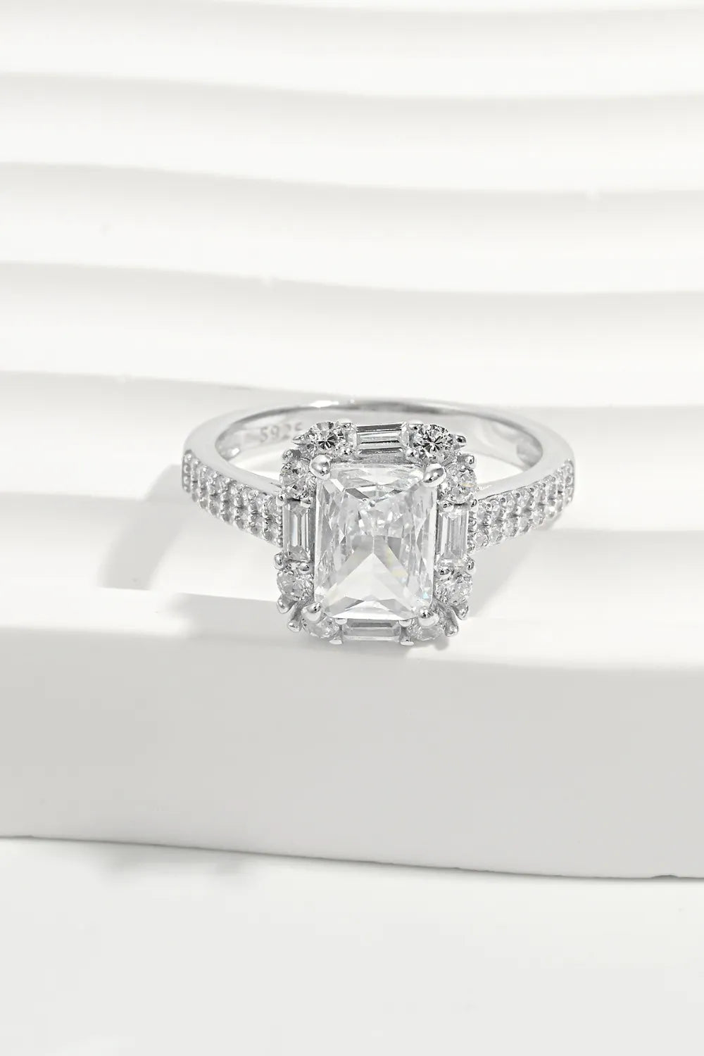 Radiant Emerald Cut Halo Ring in silver with pave band and center stone.