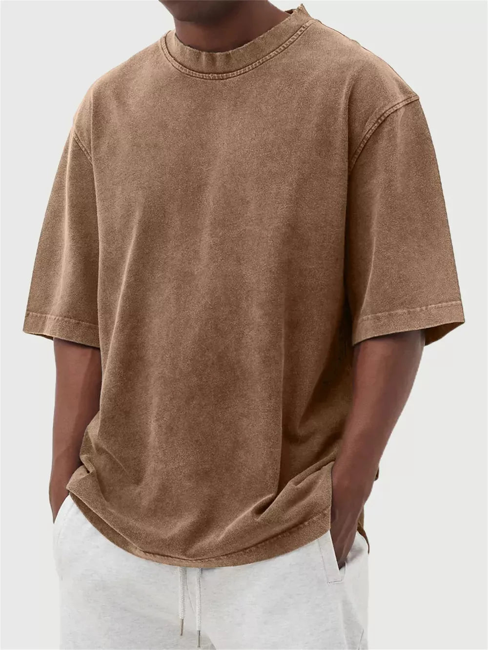 Men's dark brown vintage wash oversized crew neck t-shirt with distressed neckline.