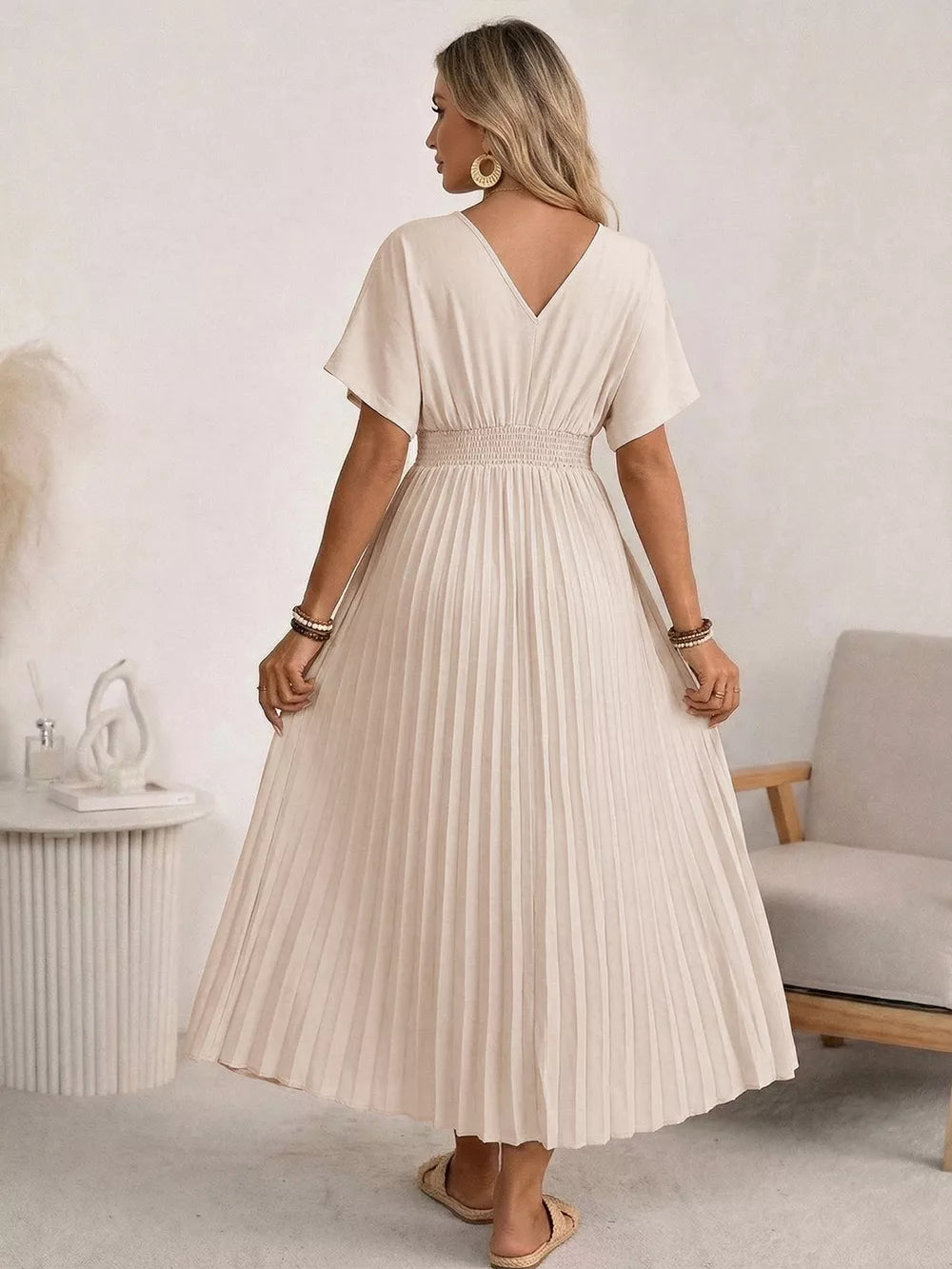 Apricot pleated V-neck midi dress with short sleeves and a smocked waist.