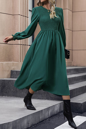 Dark green polyester midi dress with smocked bodice and long puff sleeves.