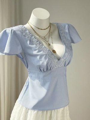 Blue striped polyester blouse with V-neck, lace trim, and flutter sleeves.