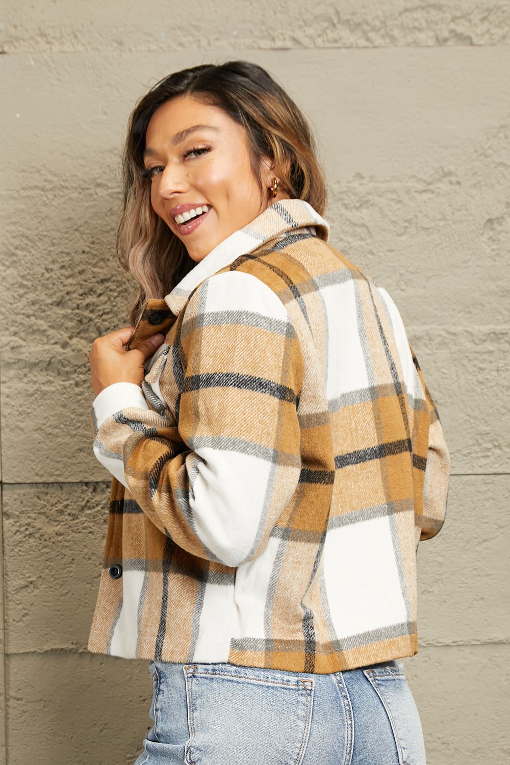 Camel plaid shacket with contrast collar and buttoned front, styled casually.