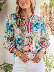 Women's cotton floral print V-neck blouse with striped trim and long sleeves.