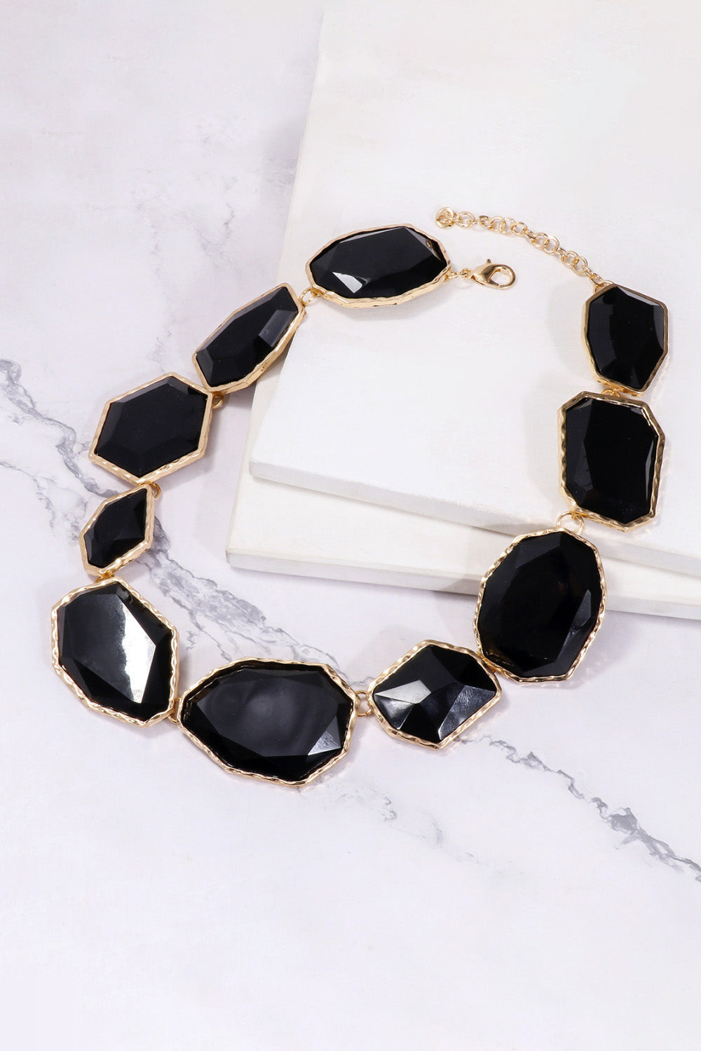 Black resin stone collar necklace with gold-tone alloy chain and clasp.