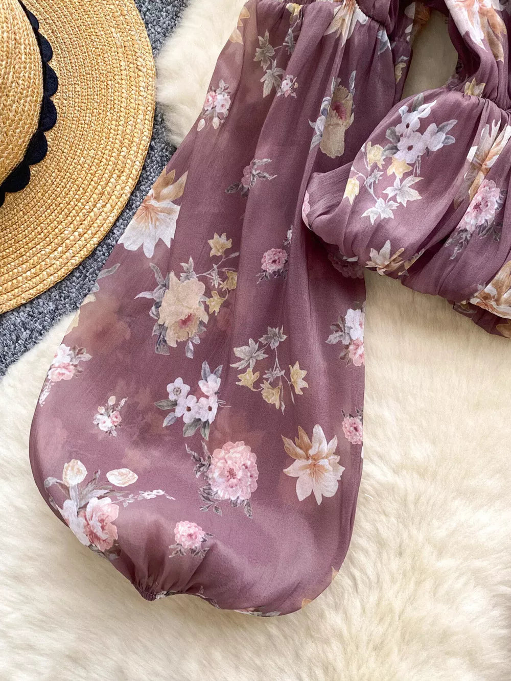 Purple floral chiffon blouse with balloon sleeves and cropped hem.