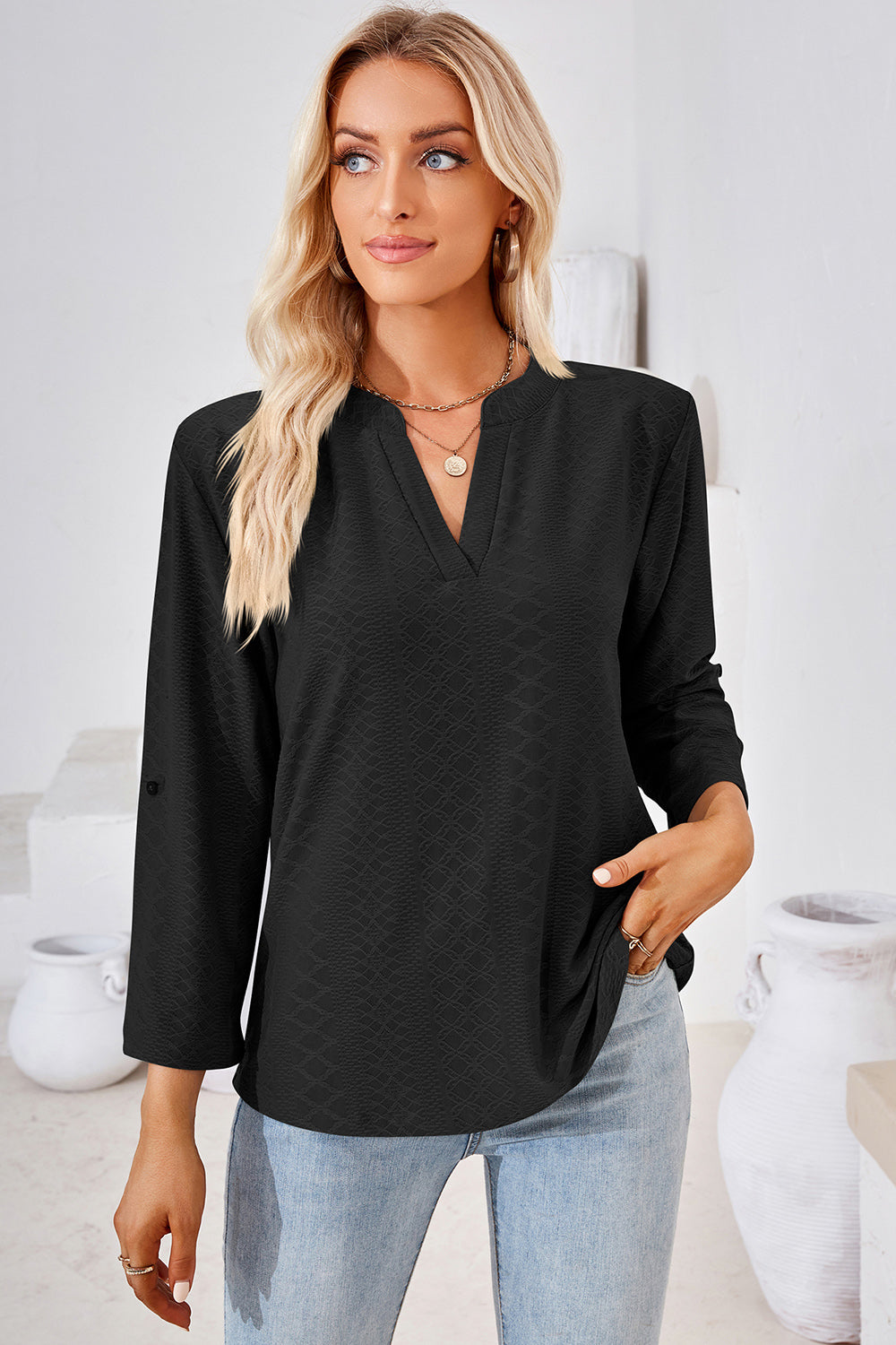 Black textured henley shirt with V-neck and roll-tab sleeves